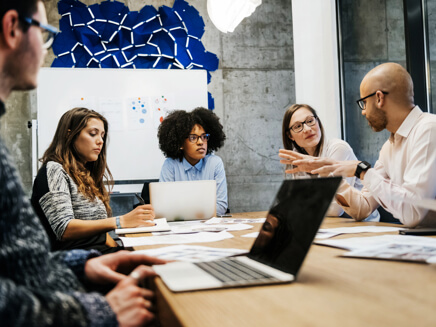 Group of people having a meeting at a conference table.